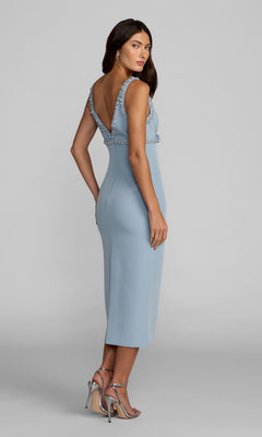 Woman in a Mac Duggal 2276 V-Neck Midi Wedding Guest Dress with bead trim and deep V-back, paired with silver heels, stands against a plain grey background.