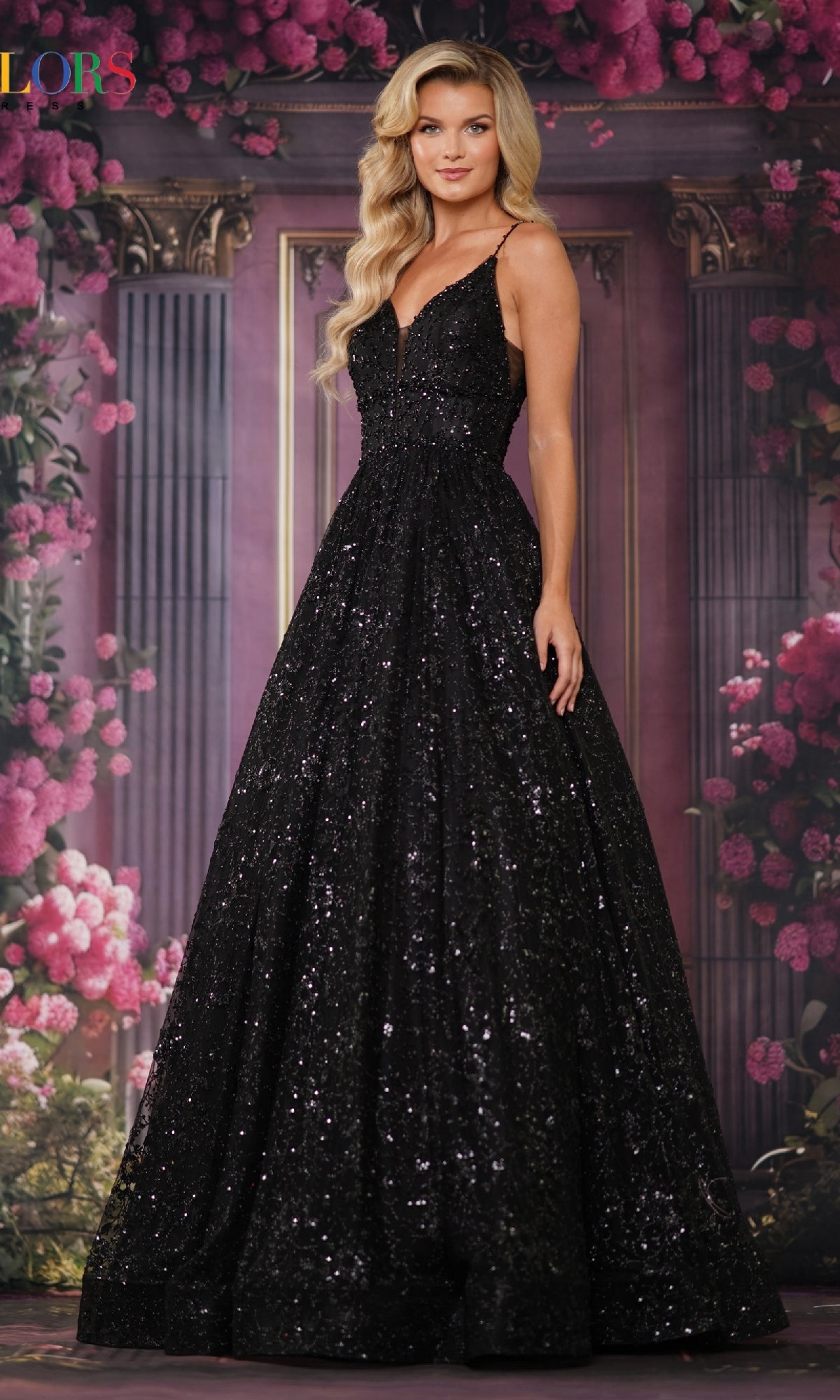 A woman wears the Long Glitter Princess Prom Ball Gown 2288, a shimmering black floor-length dress, as she stands before a floral and classical column backdrop.