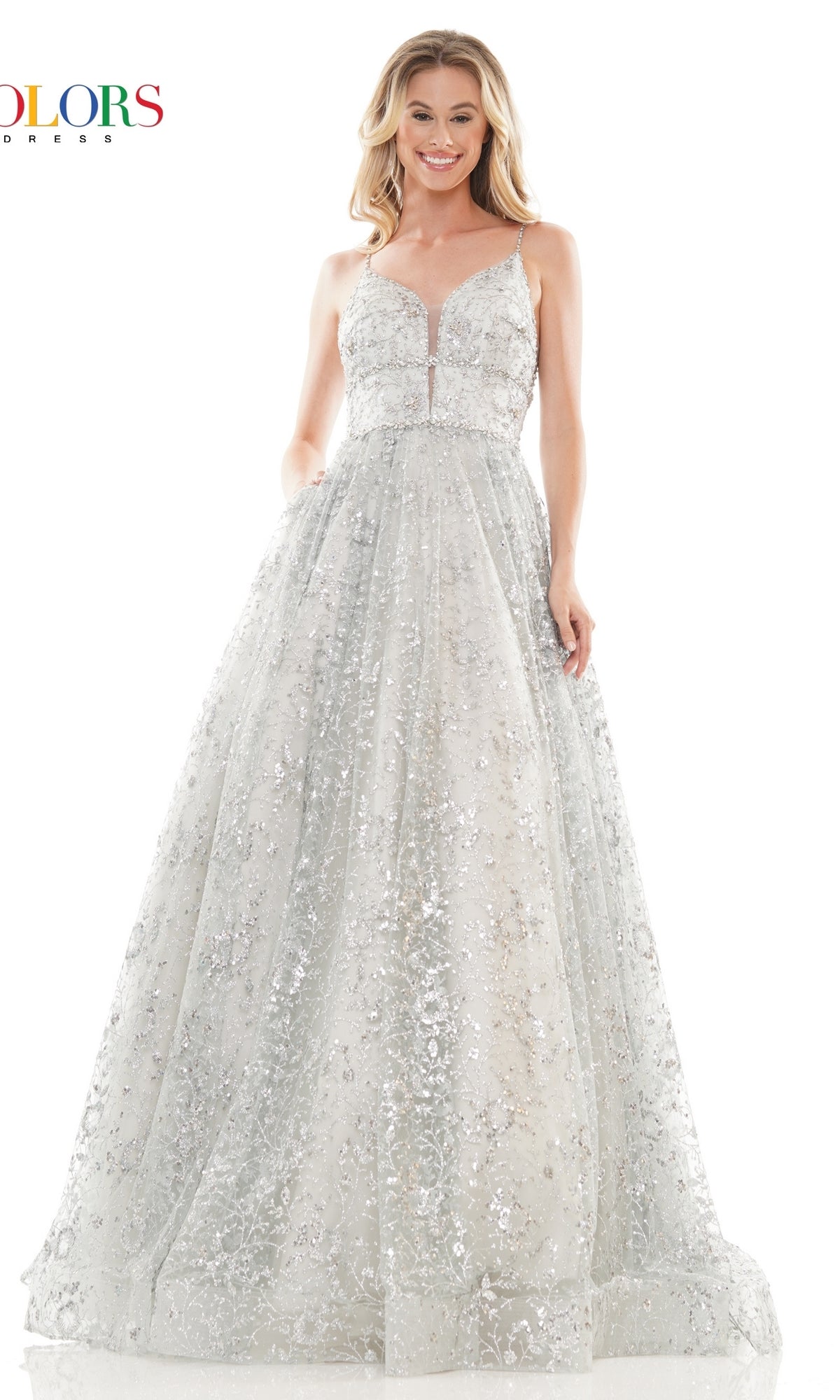 A woman wearing the Long Glitter Princess Prom Ball Gown 2288—a silver, floor-length, sleeveless sequin mesh dress—stands smiling against a white background.