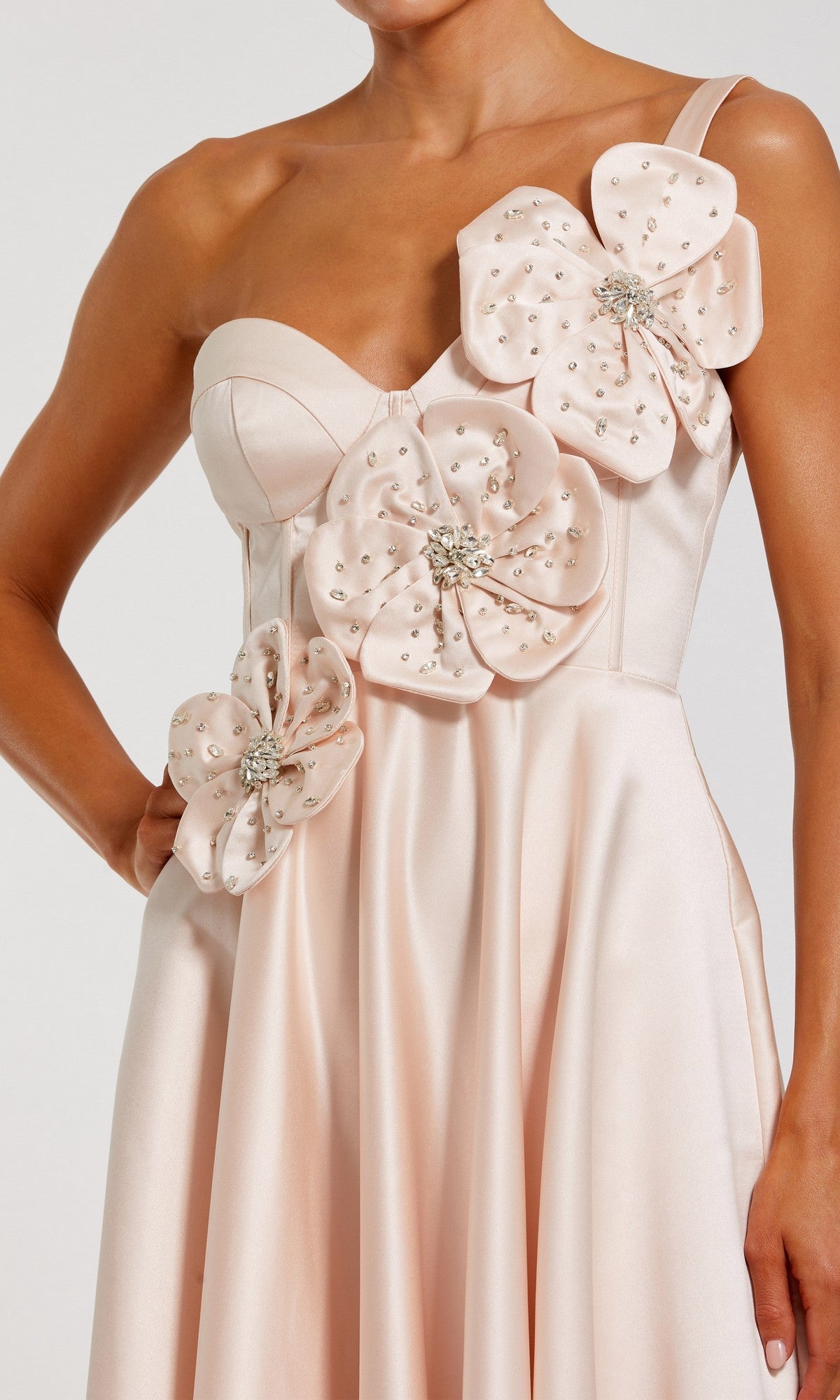 A woman wearing the Mac Duggal 2292 Long Formal Dress, a pale pink satin gown adorned with large 3D floral appliques embellished with beads, featuring a fitted bodice and thin straps.