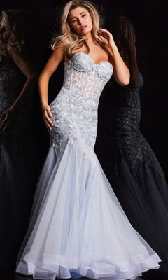 A woman poses against a black background wearing the Jovani Strapless Long Light Blue Prom Dress 22924, featuring a fitted mermaid silhouette, sheer bodice, and floral embellishments.
