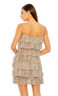 Woman in a sleeveless, backless beige Mac Duggal 23001 mini dress with layered sequined ruffles, standing and facing away.