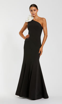 Woman wearing a black one-shoulder gown with a white flower on a white background