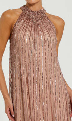 The Mac Duggal 23043 Long Formal Dress is a sleeveless, high-neck blush pink mesh gown adorned with vertical rows of sparkling beads and sequins—perfect for any formal occasion.