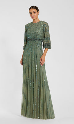 A woman wearing the Mac Duggal 23045 Long Formal Dress in seafoam—a floor-length, modest evening gown featuring three-quarter sleeves, vertical beading, and a fitted waist—stands against a plain light background.