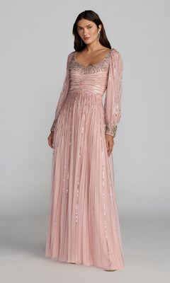 A woman wearing the Mac Duggal 23085 Long Formal Dress in Light Rose, featuring beaded embellishments on the neckline, sleeves, and cuffs, stands against a plain background.