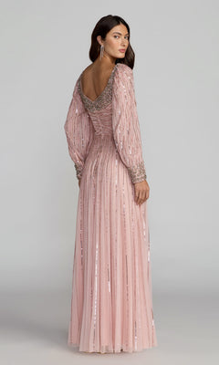 A woman stands against a plain background, looking over her shoulder and wearing the Long Formal Dress: Mac Duggal 23085—a blush pink gown with sequins, long sleeves, and a scoop back that exudes timeless elegance and sophistication.