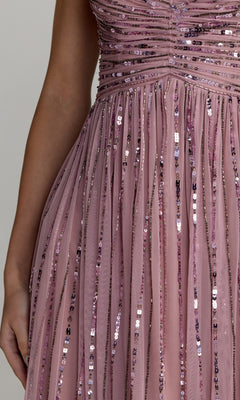 A close-up of the Mac Duggal 23098 midi party dress, featuring vertical mauve sequined stripes and ruched detailing at the bodice, worn by a person with a bare arm visible.