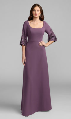 A woman stands against a plain gray background wearing the Mac Duggal 2311 Beaded-Sleeve Blue Formal Gown.