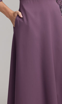 A person in the Beaded-Sleeve Blue Formal Gown: Mac Duggal 2311 stands with one hand in the pocket against a plain background.