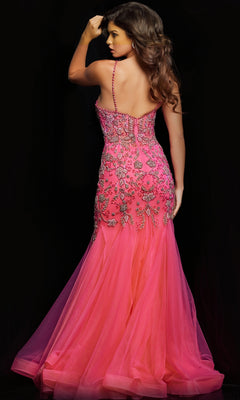 A woman faces away from the camera in the Jovani Beaded Sheer-Bodice Long Prom Dress 23125, a bright pink gown with floral embroidery and bead details, set against a black background.