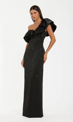 A woman poses elegantly against a plain white background, wearing the Long Formal Dress: Mac Duggal 2315 in black, which features an oversized ruffled one-shoulder detail and subtle embellishments.