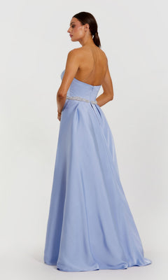 Woman in the Mac Duggal 2317 Long Formal Dress—a light blue satin gown with strapless neckline, fitted waist, and decorative belt—stands against a plain white background.