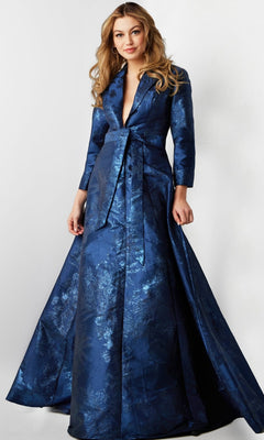 A woman wearing the Long Formal Dress: Jovani 23178—a blue brocade designer gown featuring a belted waist, long sleeves, and a deep V-neckline—stands against a plain background.