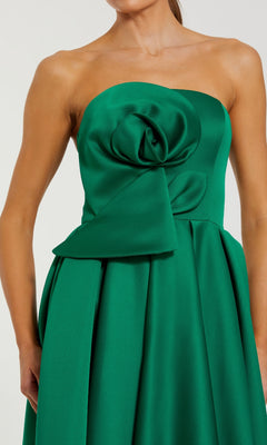 Green strapless dress with a large bow detail on a white background