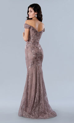 Woman wearing the Stella Couture 23357 long formal dress, an off-the-shoulder lace gown adorned with sequins, stands turned slightly to highlight the stunning back details.