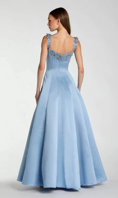 A woman is photographed from the back against a plain background, wearing the Long Formal Dress: Mac Duggal 2337—a floor-length, light blue gown featuring lace detailing on the straps.