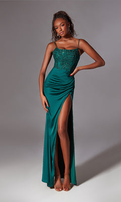 A woman in a Glitter-Bodice Long Prom Dress (Aerie Couture 233), featuring green fabric, sleeveless design, lace bodice, spaghetti straps, high slit, and open back, stands against a plain backdrop.