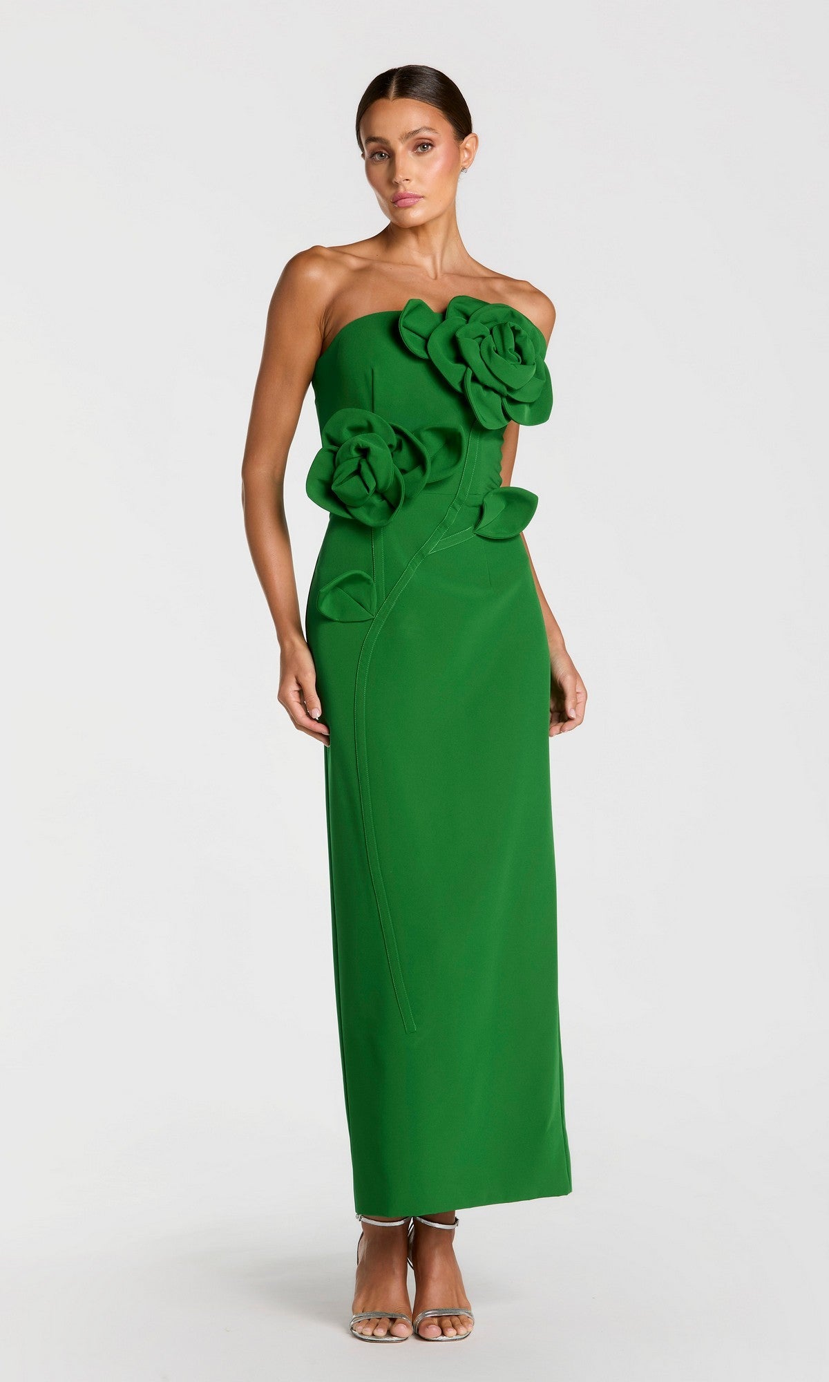 A woman stands against a plain white background wearing the Long Formal Dress: Mac Duggal 2361 in Spring Green, a strapless, floor-length gown adorned with large 3D floral appliqués.