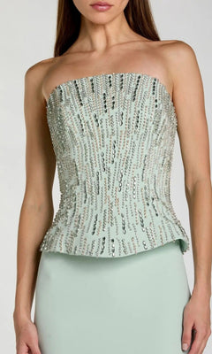 A woman wearing the Mac Duggal 2366 long formal dress—a strapless, light green gown featuring vertical rows of sequins, reminiscent of a mint-colored, elegant ensemble.