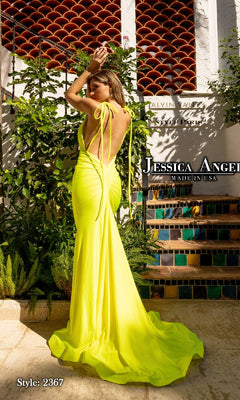Woman poses outdoors in a bright yellow shoulder-tie v-neck long prom dress, style Jessica Angel 2367. "Made in USA.