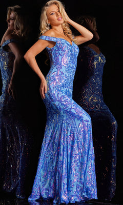 A woman poses in the Jovani Long Sweetheart Sequin-Print Prom Dress 23675—a shimmering blue, form-fitting gown—her hand in her hair, reflected against a dark background.