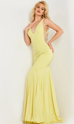 A woman poses against a white background wearing the Jovani Illusion-Sides Long V-Neck Prom Dress 23701, a sleeveless, floor-length, pale yellow gown with a deep V neckline.