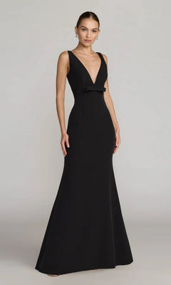A woman wearing the Mac Duggal 2371 long formal dress, a sleeveless crepe evening gown with a deep V-neckline and fitted silhouette, stands against a plain light background.