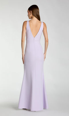 A woman faces away, showcasing the Mac Duggal 2371—an elegant long formal dress in light lavender crepe with a sleeveless design and deep V-back.