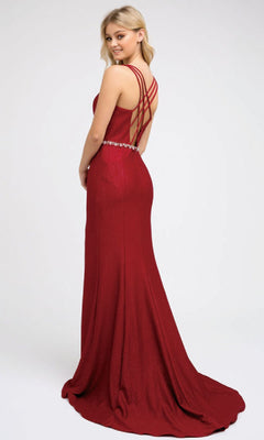 Woman wearing the Juliet 237 long prom dress, featuring a jeweled waistband, strappy crisscross back, and high leg slit, posing against a plain light background.