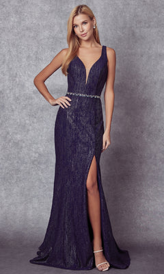 A woman models the Juliet 237 Long Prom Dress—a sleeveless, deep v-neck, navy gown with a jeweled belt, high leg slit, and strappy back—posing against a gray textured backdrop.