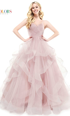 A woman stands with her hands on her hips, smiling at the camera in the Layered Long Tulle Prom Ball Gown 2381—a light pink, strapless formal dress featuring ruffles and an a-line tulle skirt.