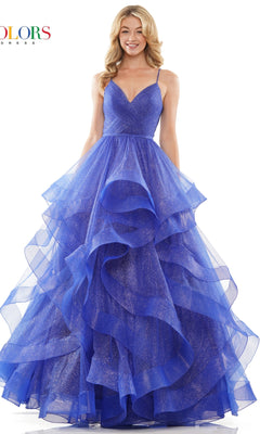 A woman wearing the Layered Long Tulle Prom Ball Gown 2381, featuring a blue sparkly design, spaghetti straps, and an a-line tulle skirt, smiles at the camera.
