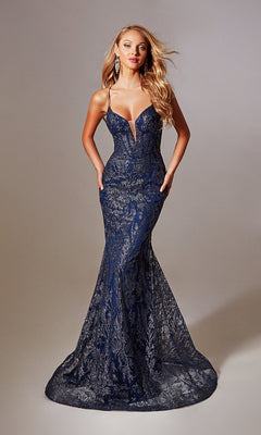 A woman poses against a plain background wearing the Aerie Couture 239, a long navy glitter prom dress with thin straps and a fitted, floor-length silhouette.