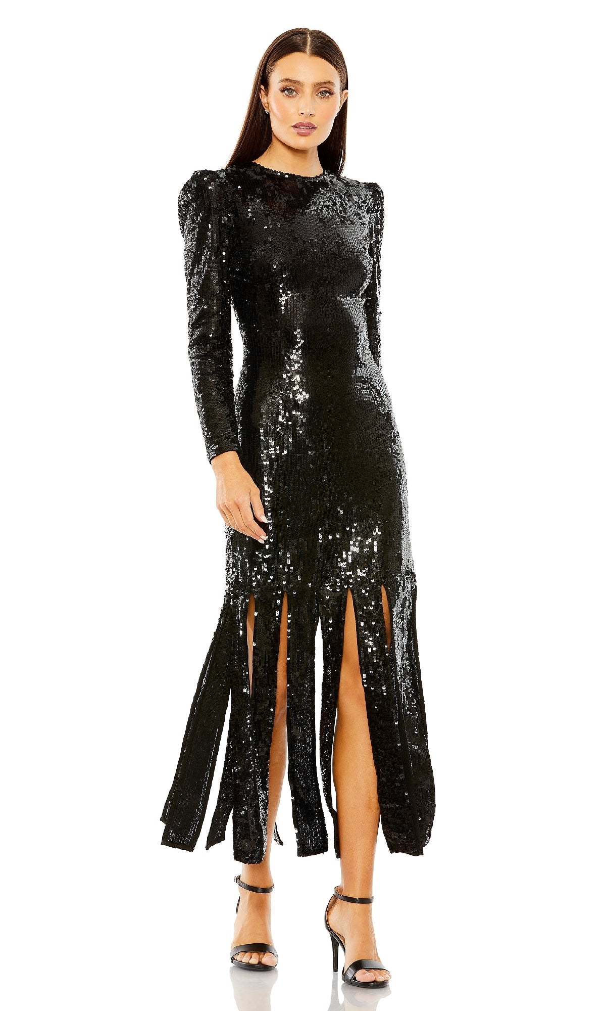 A woman models the Mac Duggal 24008 midi black sequin formal dress—featuring long sleeves, multiple front slits, and paired with high-heeled sandals—against a white background.