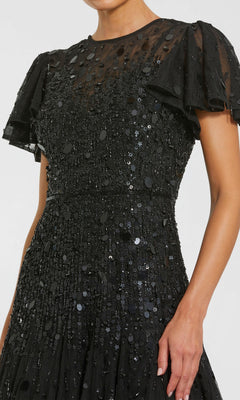 A woman wearing the Mac Duggal 24018: a brown, tea-length party dress designed by Mac Duggal.