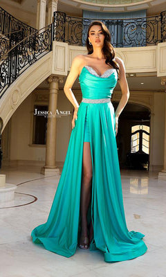 Woman modeling the Strapless High-Low Prom Dress Jessica Angel 2402 in turquoise with silver accents and a thigh-high slit, posed elegantly on marble floors beside a curved staircase.