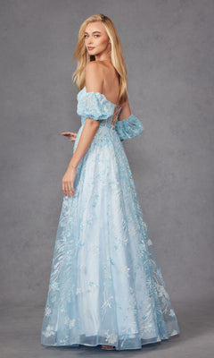 A woman poses against a plain gray background, wearing the Puff-Sleeve Strapless Long Glitter Prom Dress 2404 in light blue, looking over her shoulder.