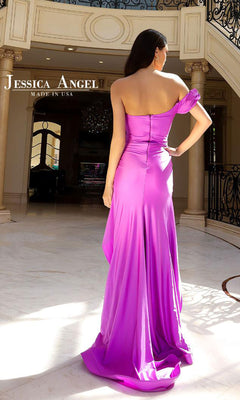 A woman stands in an elegant, marble-floored interior with a staircase and chandelier, wearing the Jessica Angel 2408 One-Shoulder Ruffle Prom Gown.
