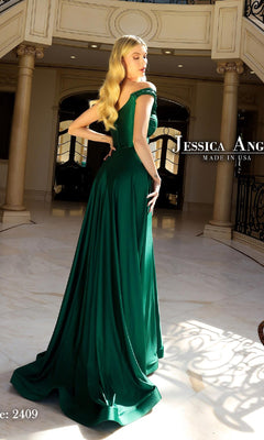 A woman with long blonde hair wears the Jessica Angel 2409 Classic A-Line Long Prom Dress in green, standing in an elegant interior with marble floors and columns.