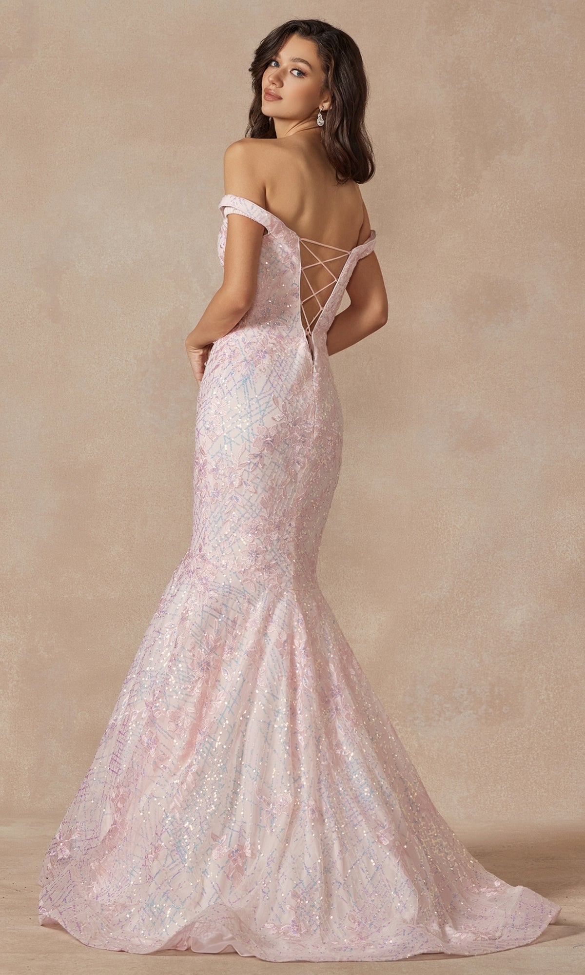 A woman models the Off-the-Shoulder Sequin Mermaid Prom Dress 2412 in light pink, featuring iridescent sequins, a lace-up back, and mermaid silhouette, standing against a neutral background.