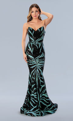 A woman stands gracefully against a plain light gray background, wearing the Long Prom Dress 24134 by Stella Couture—a strapless, floor-length black gown adorned with teal sequin patterns.