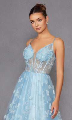 A woman models the Sheer-Corset Glitter-Print Long Prom Dress 2413, featuring a light blue, sheer a-line design with thin straps and floral lace, set against a plain gray background.