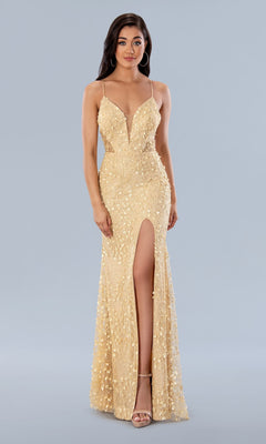 A woman wears the Long Prom Dress 24185 by Stella Couture—a gold beaded formal gown with a deep V-neck, thin straps, sequin details, and a thigh-high slit—paired with strappy heels.