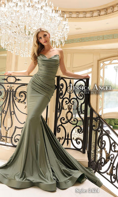 A woman in a sexy, olive green Jessica Angel 2424 strapless mermaid formal dress poses on a staircase beneath elegant chandeliers.