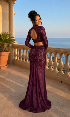 Woman in a Lace Two-Piece Long Prom Dress stands on a stone terrace overlooking the sea, smiling and facing away from the camera, showing off the elegant lace details of her floor-length gown.