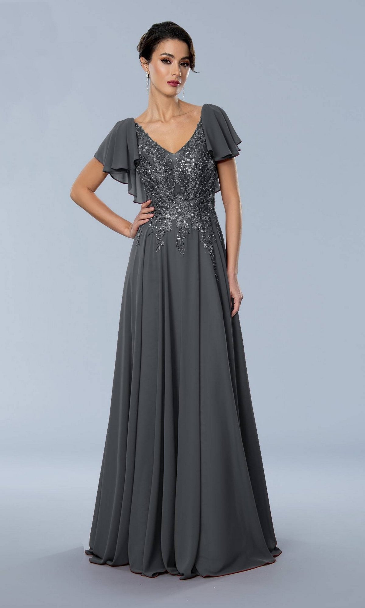 Charcoal Stella Couture 24352 evening gown featuring a V-neck, sequined bodice, and flutter sleeves in a floor-length formal style.