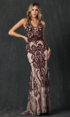 A woman poses in front of a dark textured background, wearing the Juliet 243: a form-fitting, sleeveless, floor-length prom dress featuring intricate burgundy lace over a nude base.