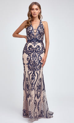 A woman models the Juliet 243 Long Prom Dress, a sleeveless, floor-length gown with intricate navy blue embroidery over nude fabric, set against a plain light background.
