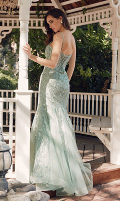 A woman wearing the Juliet JT2441S Long Sequin Mermaid Prom Dress in pale green stands under a white gazebo, gazing over her shoulder.
